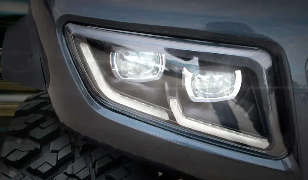 A close-up photograph of the headlight of one of the golf cart models available at Luxury Electric GM