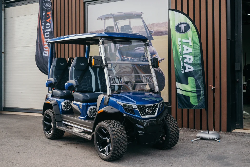 An Evolution D-MAX golf cart traveling through the streets of a residential neighborhood, providing efficient mobility, a comfortable ride, and everyday safety.