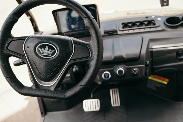 Close-up of the steering wheel and pedals: Advantages of choosing an electric golf cart over a gasoline one
